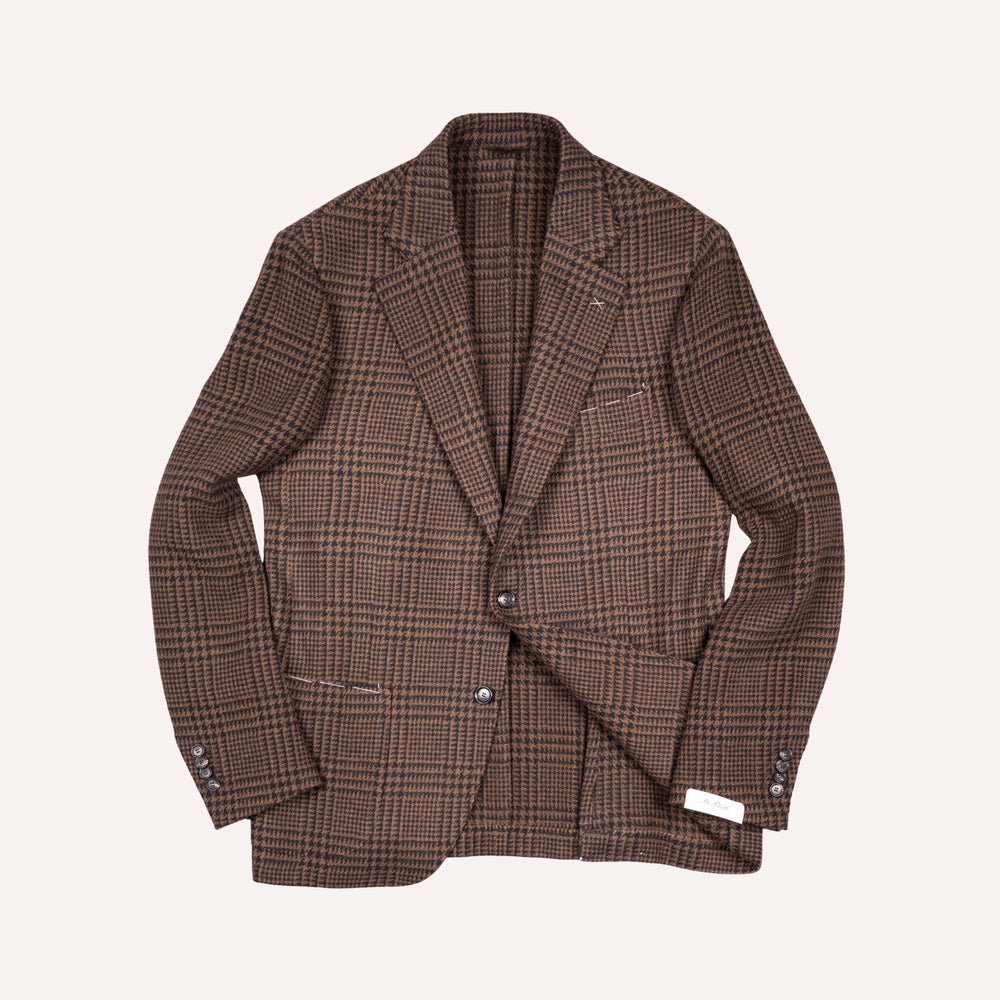 A brown and beige plaid blazer jacket with notched lapels and a two-button closure, laid flat against a light cream background.