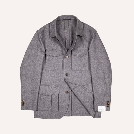 A gray textured wool-blend utility jacket with a collar, button front, and multiple front pockets, displayed flat against a light cream background.