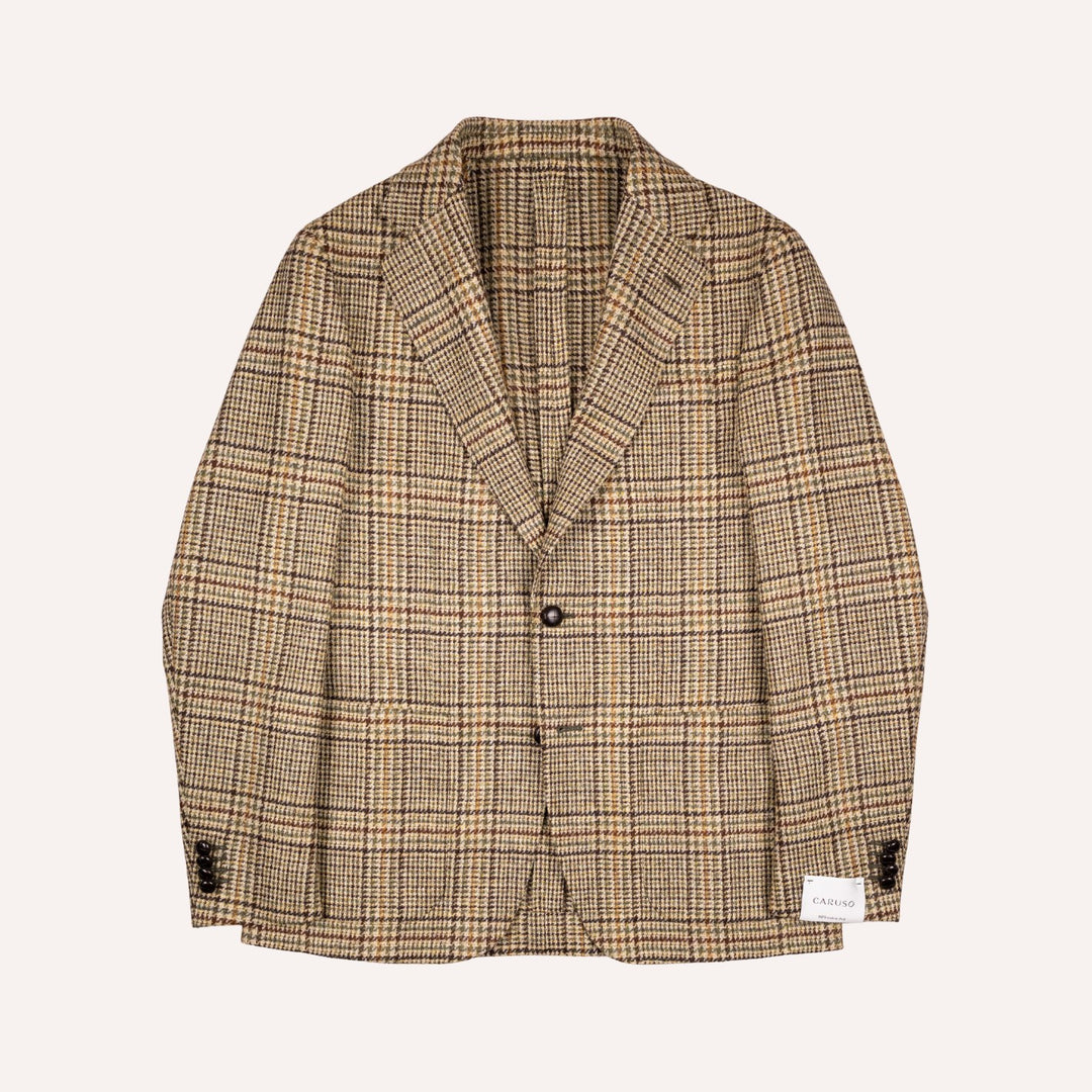A beige and brown plaid blazer jacket with a two-button closure, laid flat against a light cream background.