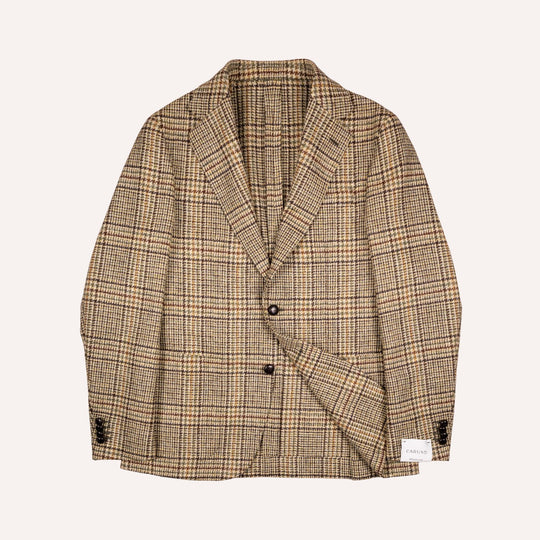 A men's single-breasted blazer in a beige and brown plaid pattern, featuring notch lapels, two dark buttons, and a small white brand label on the lower right front hem, displayed against a solid off-white background.