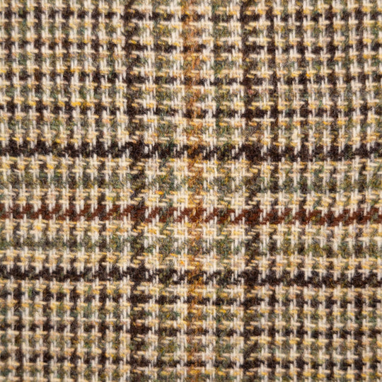A close-up of a textured woven fabric with a houndstooth and plaid pattern in beige, brown, olive green, and dark brown.