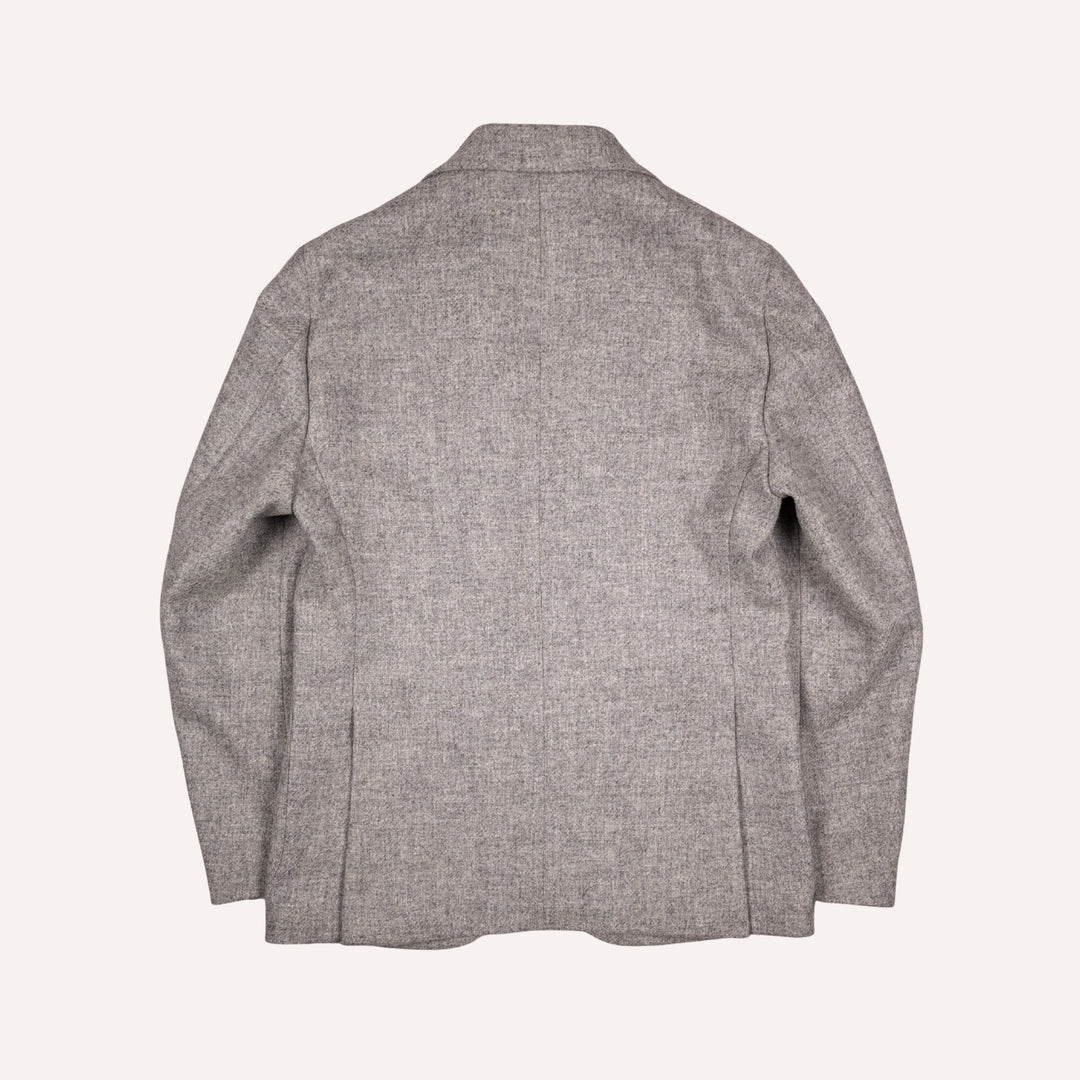 The back view of a light gray textured blazer, displayed flat against a solid off-white background.