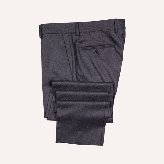 Dark charcoal gray dress pants folded neatly on a light cream background, showing the back waistband, belt loops, and a rear welt pocket.
