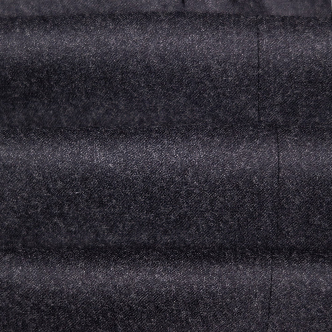 A close-up of dark charcoal gray textured fabric with horizontal quilting and a vertical seam.