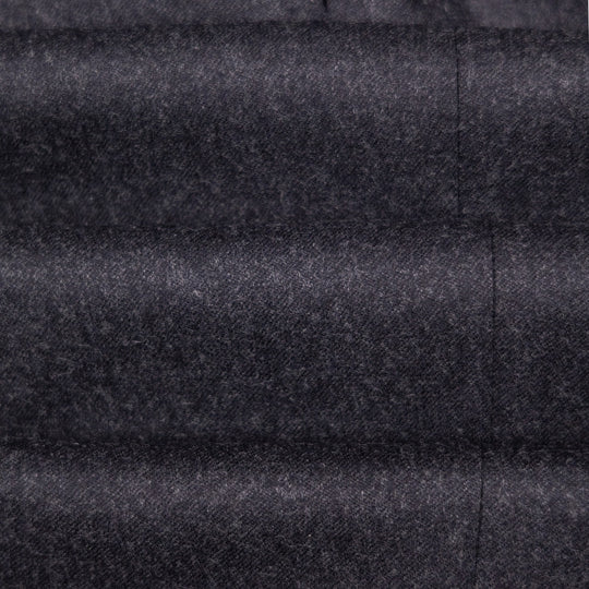 A close-up of dark charcoal gray textured fabric with horizontal quilting and a vertical seam.