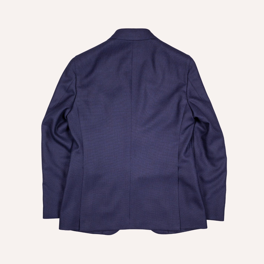 A navy blue textured blazer shown from the back, laid flat against a light cream background.