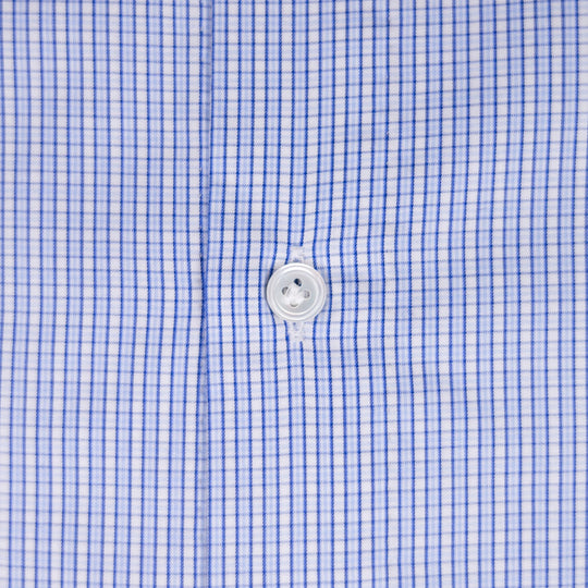 Close-up of a blue and white gingham checkered shirt fabric with a white button at the center.