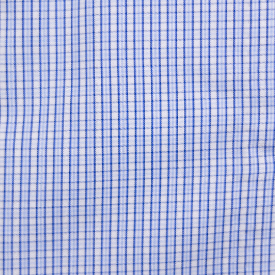 A close-up of a white fabric with a fine blue gingham check pattern.