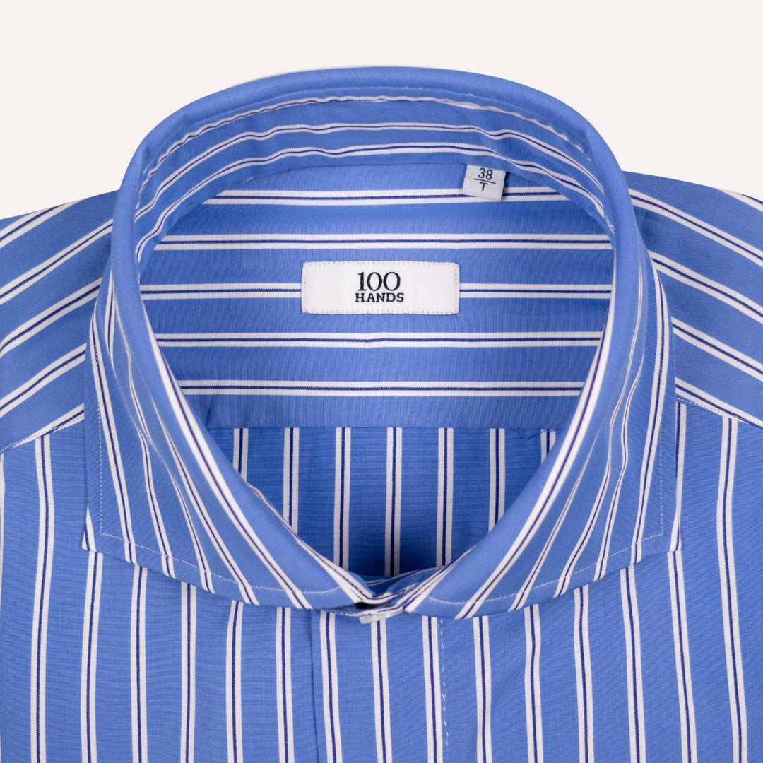 Close-up of a blue and white striped dress shirt collar with a visible neck label reading '100 HANDS'.