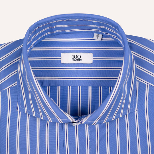 Close-up of a blue and white striped dress shirt collar with a visible neck label reading '100 HANDS'.