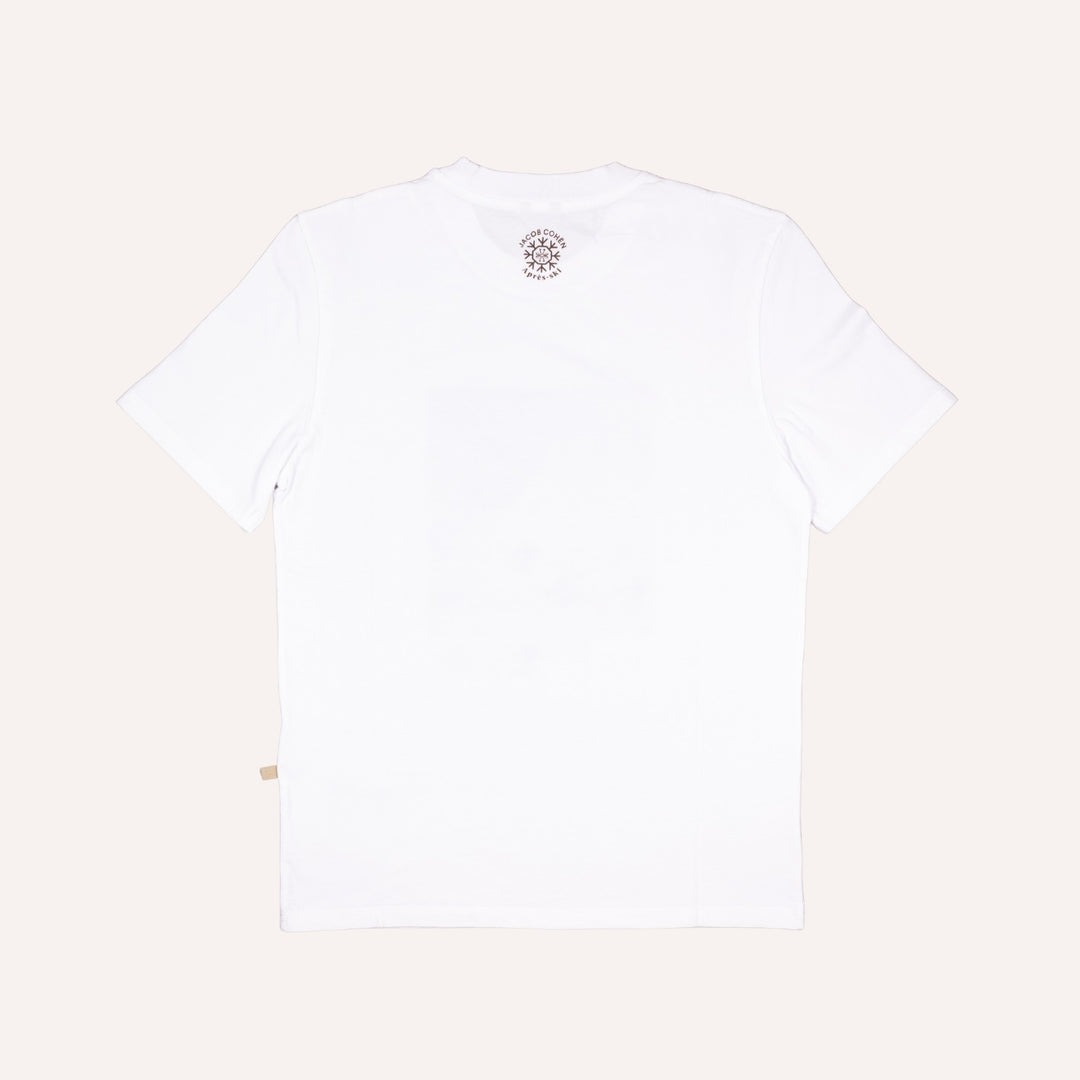 White short-sleeve crewneck t-shirt shown from the back, featuring a small circular graphic print near the inner neckline and a small beige tag near the bottom left hem, set against a solid off-white background.