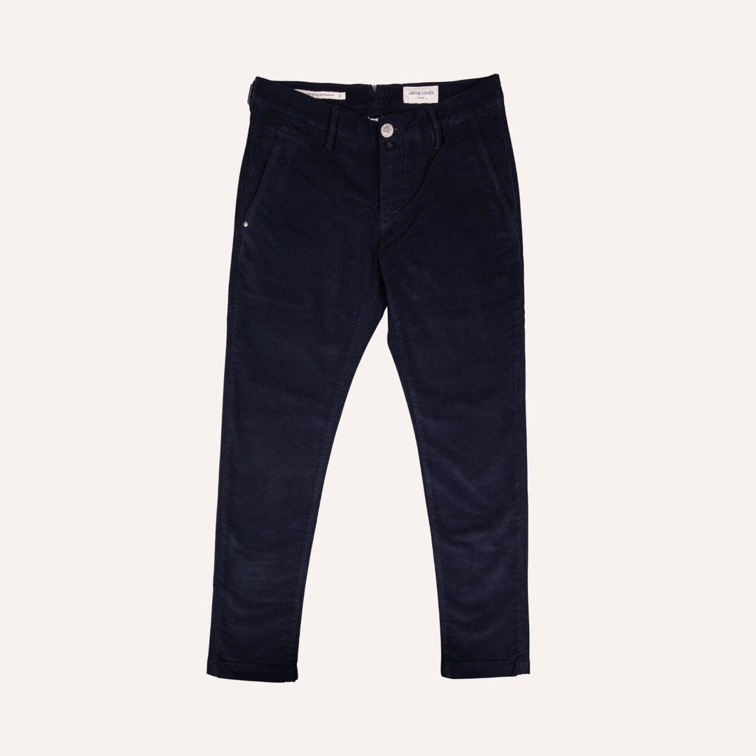 A pair of dark navy blue twill trousers shown flat against a light cream background.
