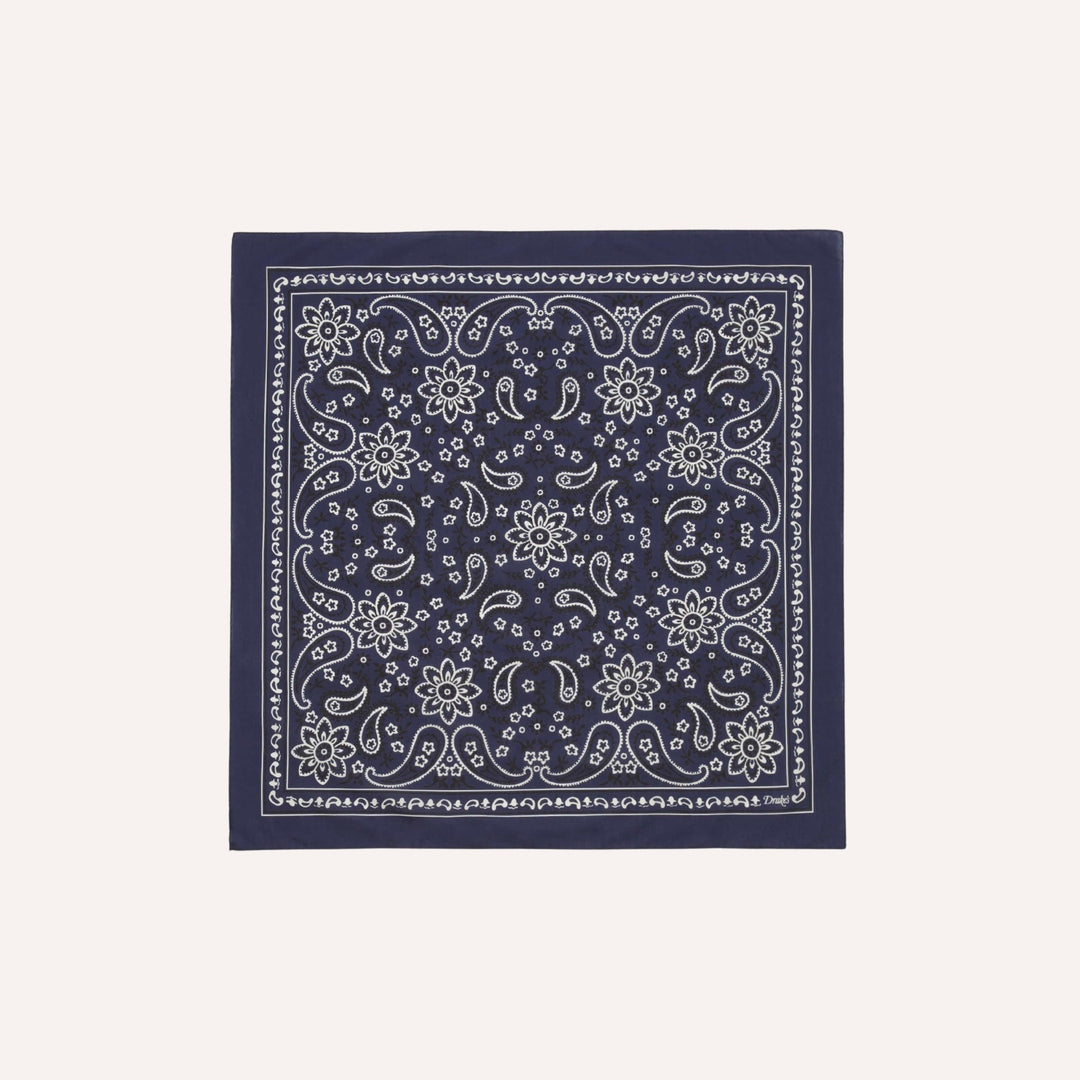 Navy blue bandana with white floral pattern on a light gray background
