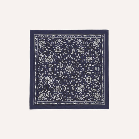 Navy blue bandana with white floral pattern on a light gray background