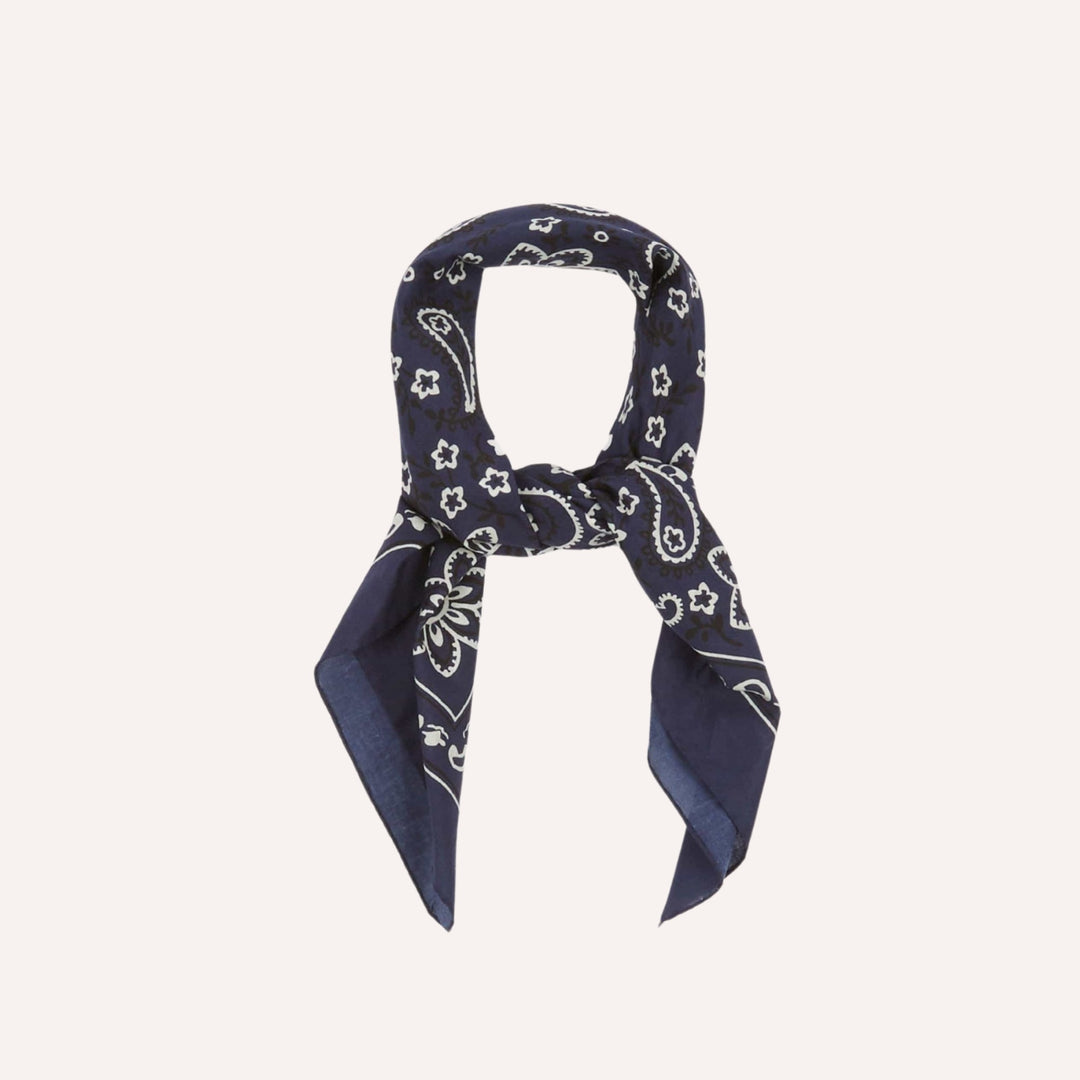 Navy blue bandana with white patterns on a light gray background