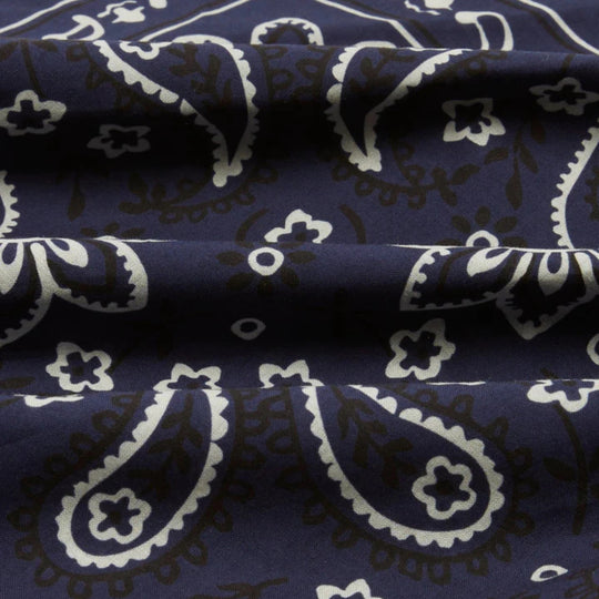 Navy blue fabric with white paisley patterns