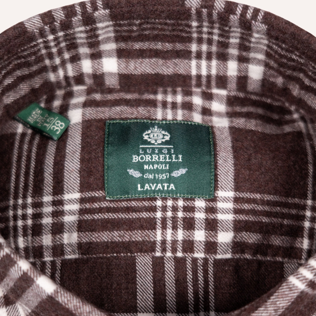 Close-up of a brown and white plaid wool fabric interior with a green sewn-in label reading 'LUIS BORRELLI NAPOLI LAVATA' and a small side tag.