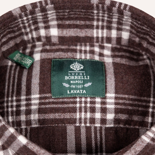 Close-up of a brown and white plaid wool fabric interior with a green sewn-in label reading 'LUIS BORRELLI NAPOLI LAVATA' and a small side tag.